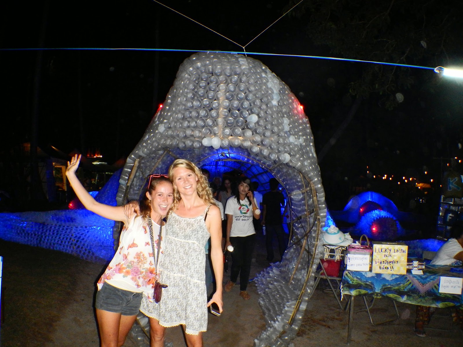 Me and Maike standing in front of a whale made out of re-purposed water bottles at the Koh Tao Festival