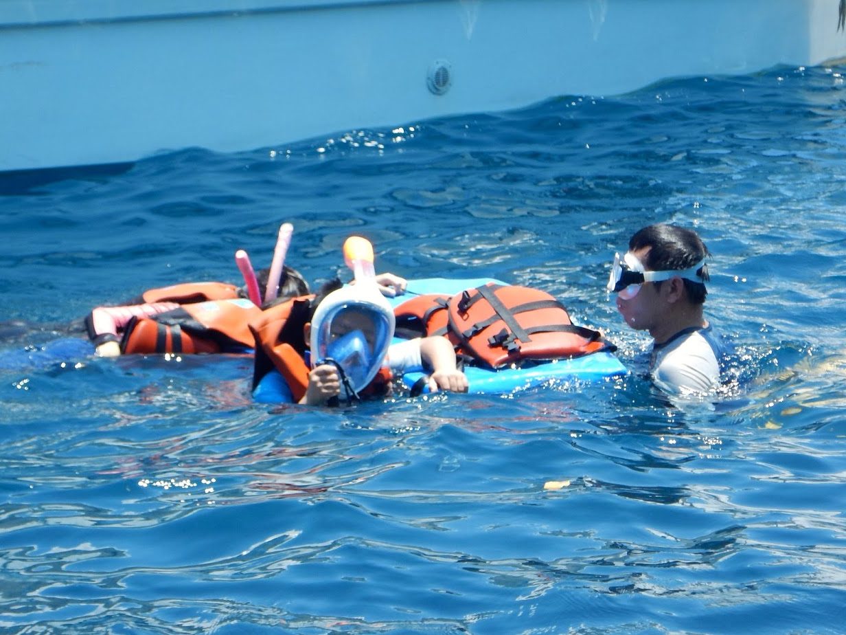 Chinese tourists wearing full-face snorkels and looking ridiculous