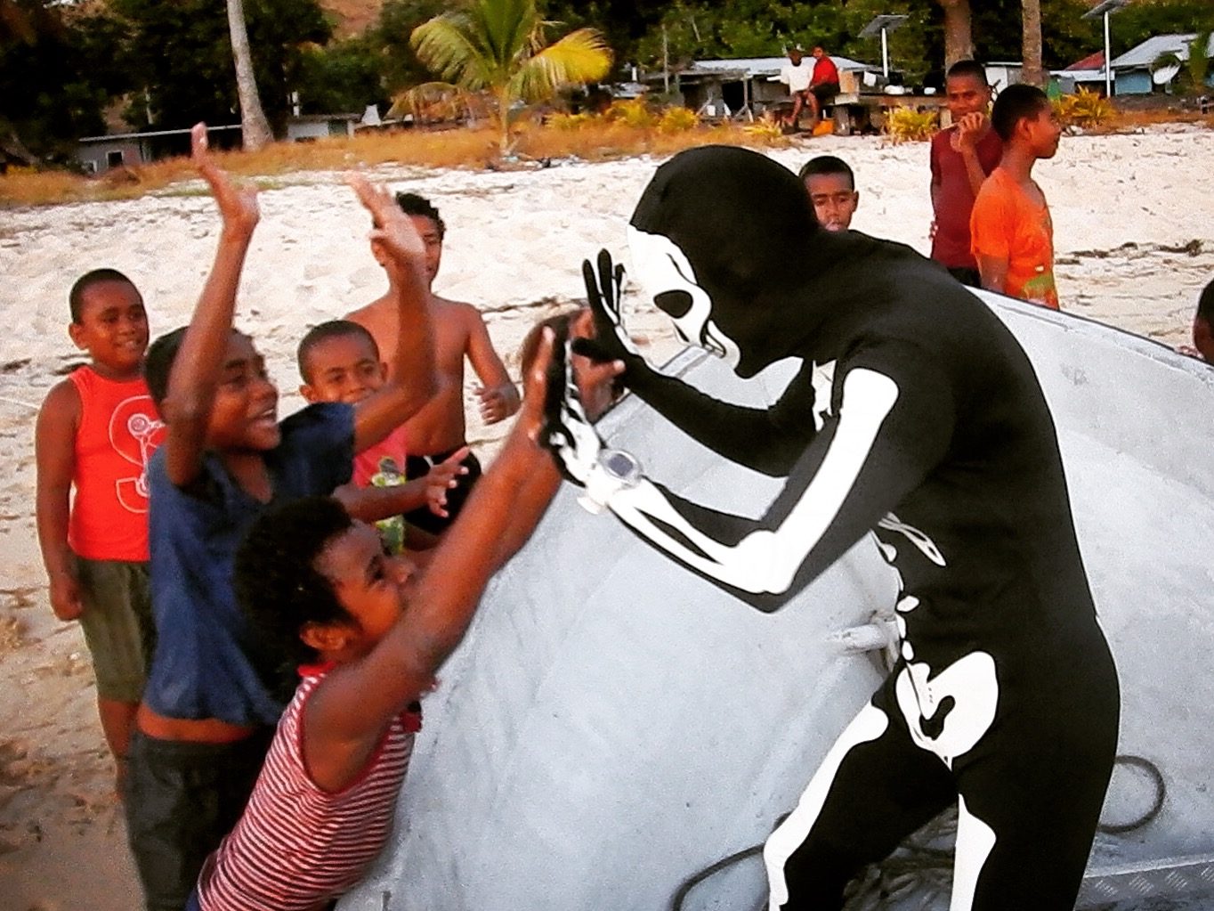me dressed up in a skeleton morph suit for halloween playing with the local kids in Fiji