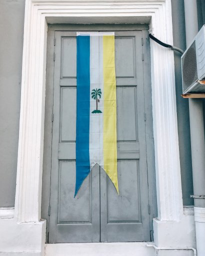 Flag of Penang hanging over a doorway.