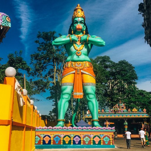 The Art Gallery Cave's entrance is located behind the giant green statue of Hanuman.